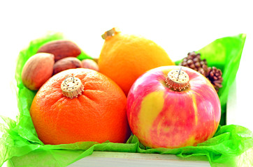 fruits like a christmas ornaments in a white wooden box