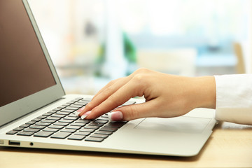 female hand writing on  laptot, close up