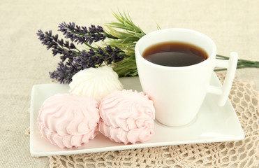 Marshmallows on plate on light background