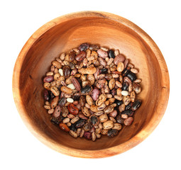 Beans in wooden bowl isolated on white