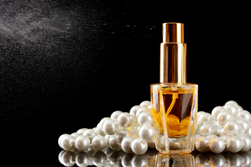 women's perfume in beautiful bottle and beads,