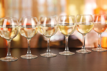 White wine in glass on room background