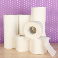 Rolls of toilet paper on purple with dots background
