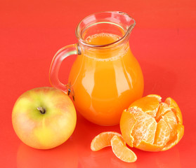 Full jug of multivitamin juice on color background