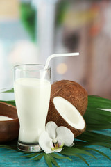 Coconut with glass of milk,  on blue wooden table