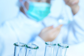 laboratory assistant analyzing a liquid