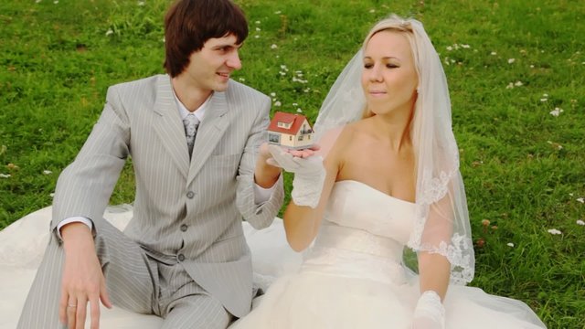groom gets breadboard model of small house and gives to its