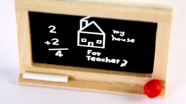 Toy blackboard circling with drawing, inscription and