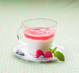 Cup of yoghurt topping with raspberry jelly