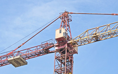 A red and yellow construction hoisting crane