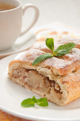 slice of an apple strudel with tea