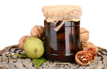 jam-jar of walnuts  on wicker mat