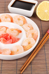 Prawns on plate with chopsticks and sauce
