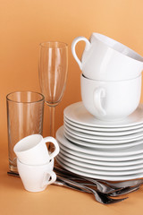 Clean white dishes on beige background