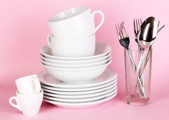 Clean white dishes on pink background