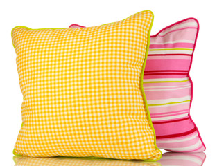 Yellow and pink bright pillows isolated on white