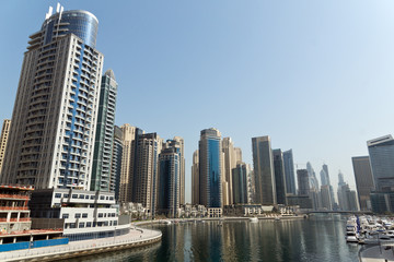 Fototapeta na wymiar Dubai Marina Yacht and Skyscrapers
