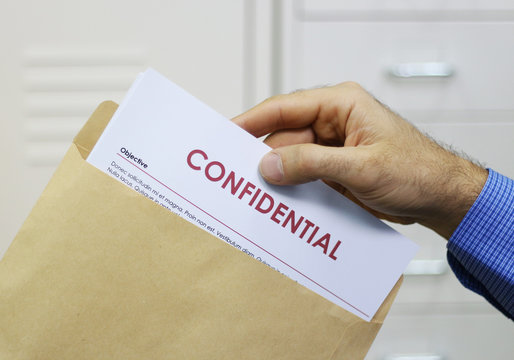 Man handling confidential documents