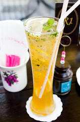 Lemon ice tea with with mint leaves and lemon sice on wood table