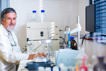Fototapeta na wymiar Senior male researcher carrying out scientific research in a lab