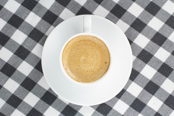 coffee on a checkered tablecloth top view