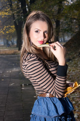 WOMAN IN AUTUMN PARK