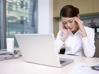 asian businesswoman sitting and thinking in office