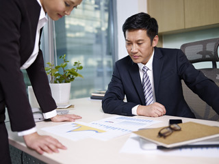 manager reviewing business with subordinate