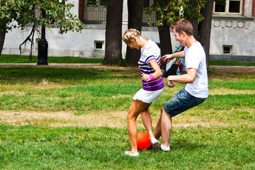 Fototapeta premium man and woman playing football in the park