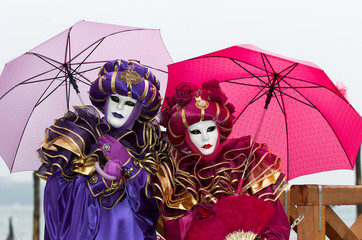 Person in Venetian costume attends Carnival of Venice.