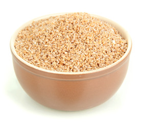 Brown bowl full of wheat bran isolated on white