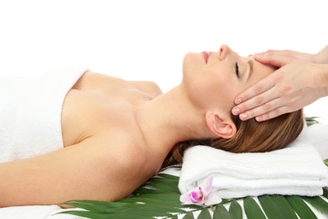 Fototapeta na wymiar Portrait of beautiful woman in spa salon taking head massage