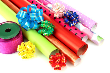 Rolls of Christmas wrapping paper with ribbons, bows isolated