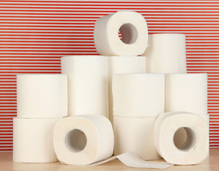 Rolls of toilet paper on striped red background