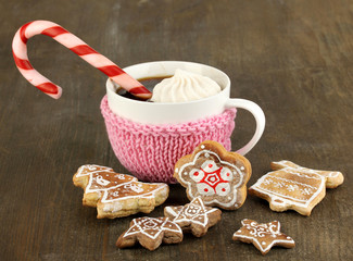 Cup of coffee with Christmas sweetness on wooden table close-up