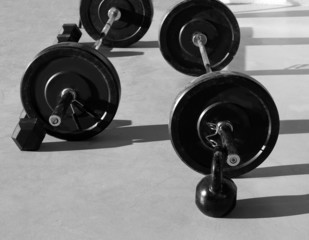 Naklejka na ściany i meble Kettlebells at crossfit gym with lifting bar weights