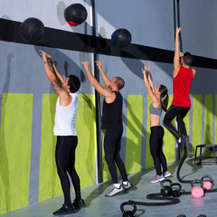Crossfit workout people group with wall balls and rope