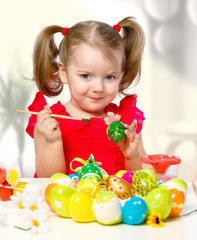 girl paints eggs