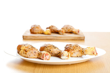 Marinated chicken legs on plates