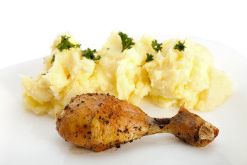 Roasted chicken with potato on plate