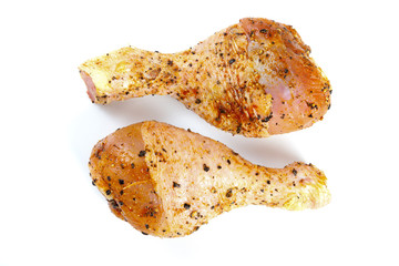 Marinated chicken legs isolated on white
