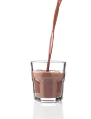 Filling glass of chocolate milkshake
