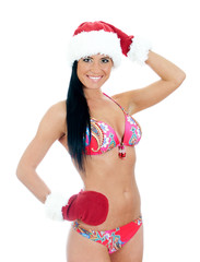 Young sexy woman wearing bikini and christmas hat and gloves