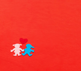 multicolored paper boy and girl with red paper hearth