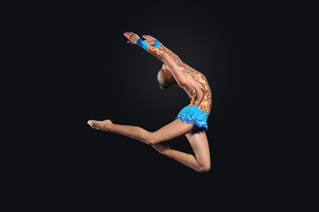 Young woman in gymnast suit posing