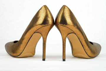 Pair of golden colored High Heel