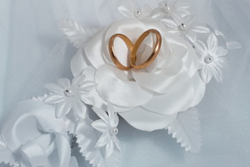 Two wedding rings and wedding background