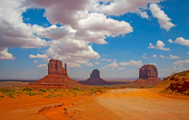 Monument Valley landscape with clouds and dirt road