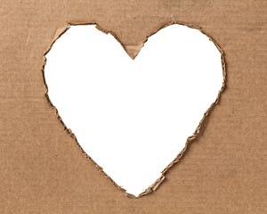 hole in a shape of heart on cardboard