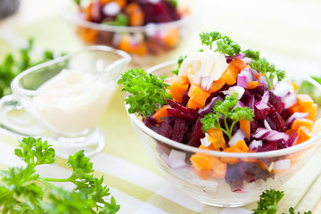 salad with baked vegetables and herring